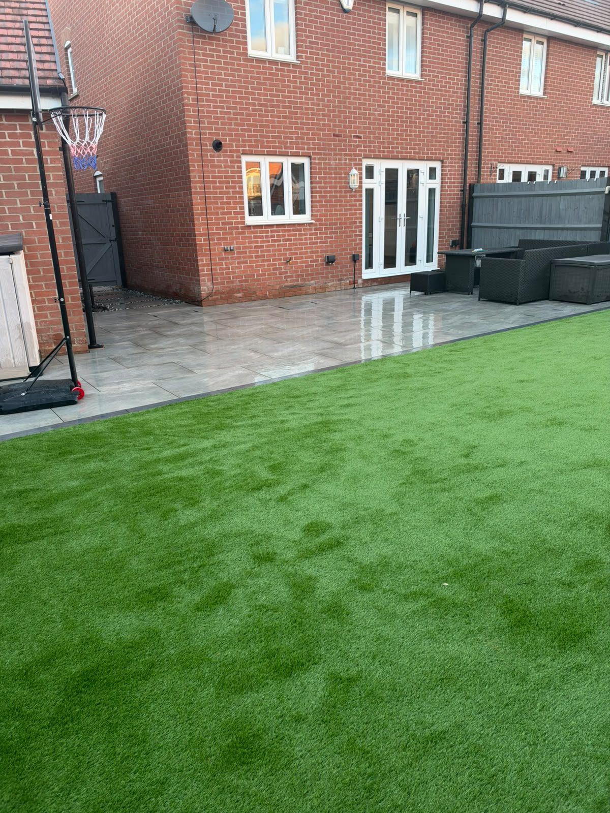 Grey patio and artificial grass, both installed by Progreen in Newton Leys, Milton Keynes