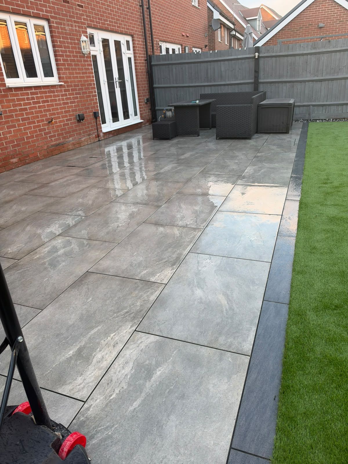 Close-up of Progreen patio paving, artificial grass and the dark border in Newton Leys
